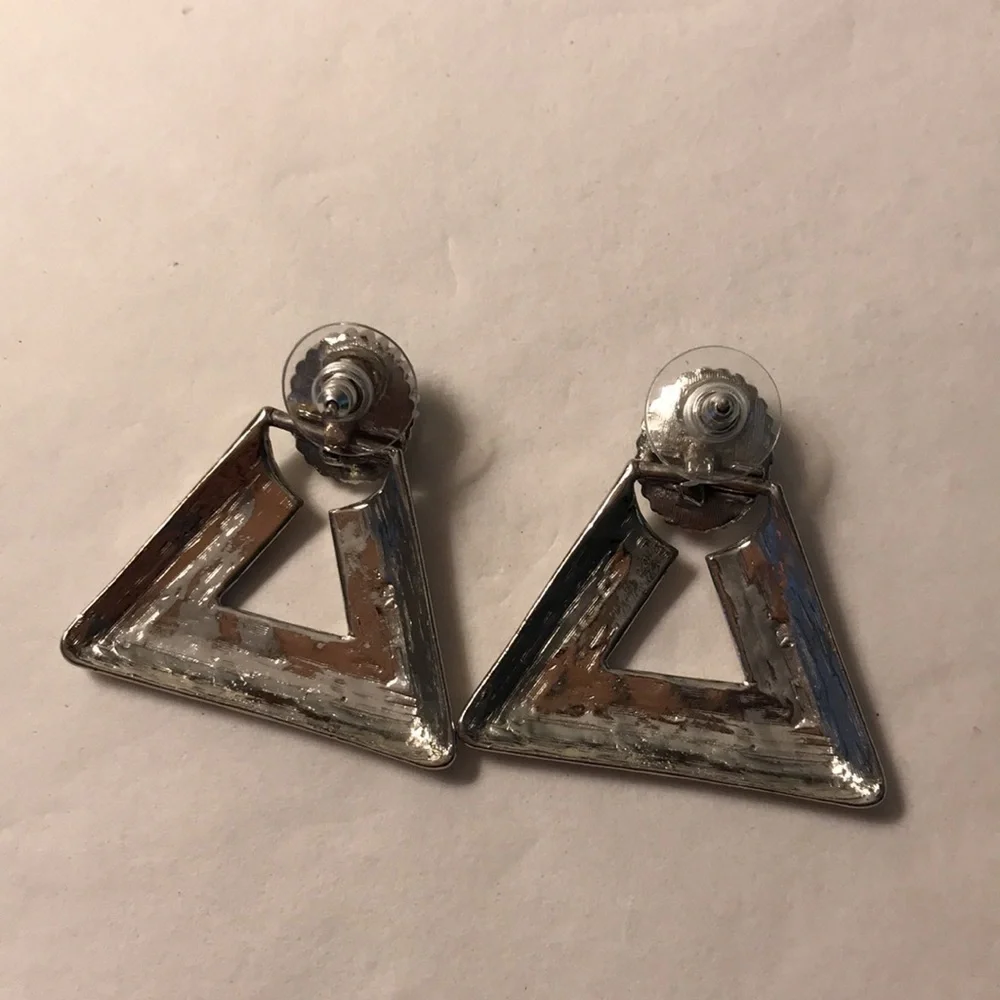 Silver triangular shaped earrings turquoise colored stone at peak that swivels